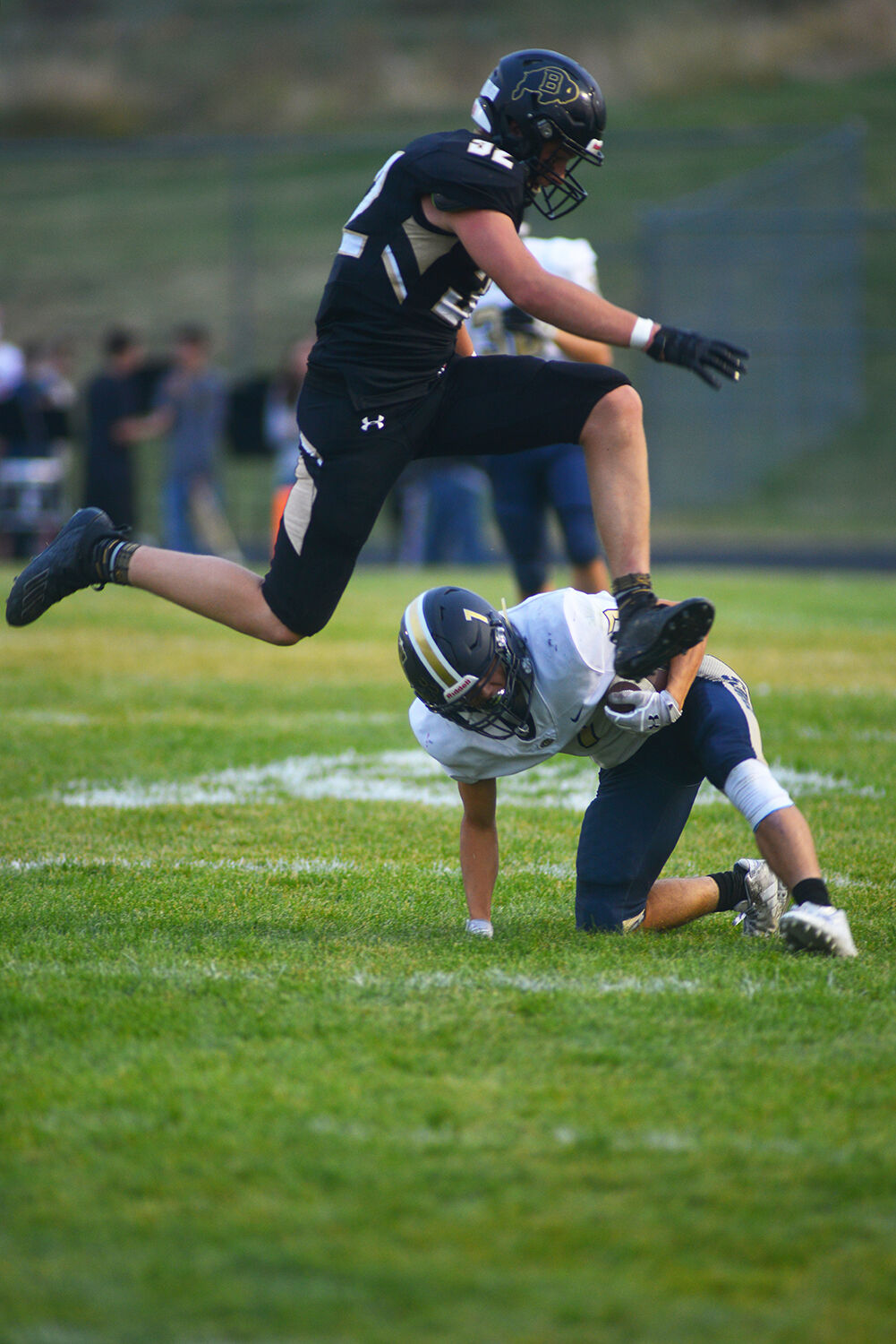 Calvin Rule jumps over the fallen Cody ball carrier